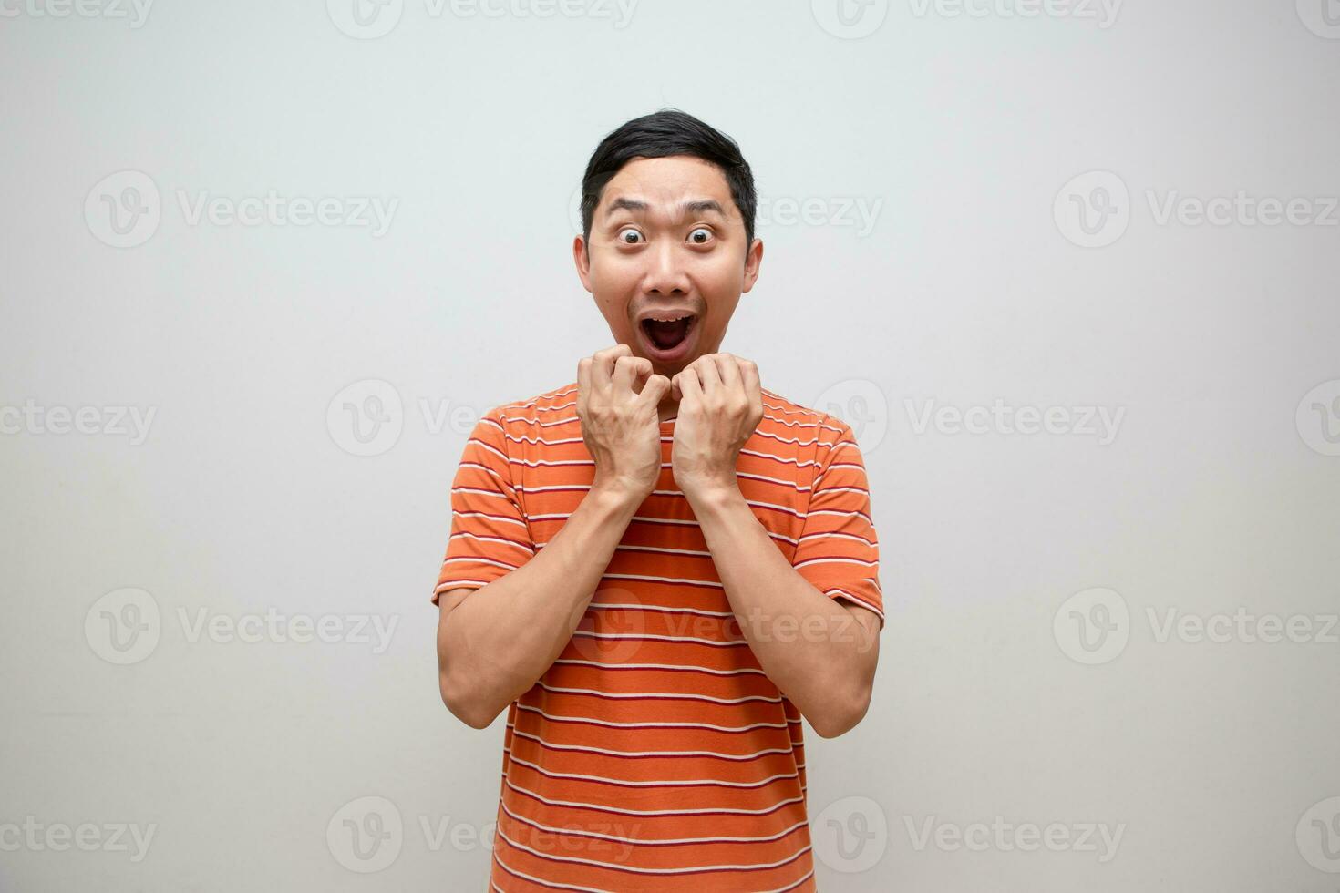 Asian man orange shirt feels excited shocked face isolated photo