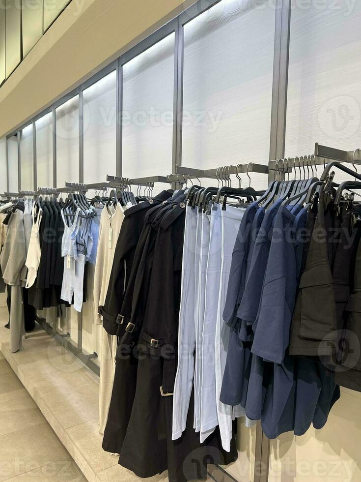 Clothes hang on a hanger. Style and wardrobe for women. Shopping center and shopping. photo