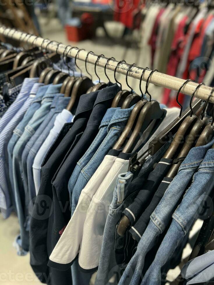 clothes on a hanger in a store for men photo