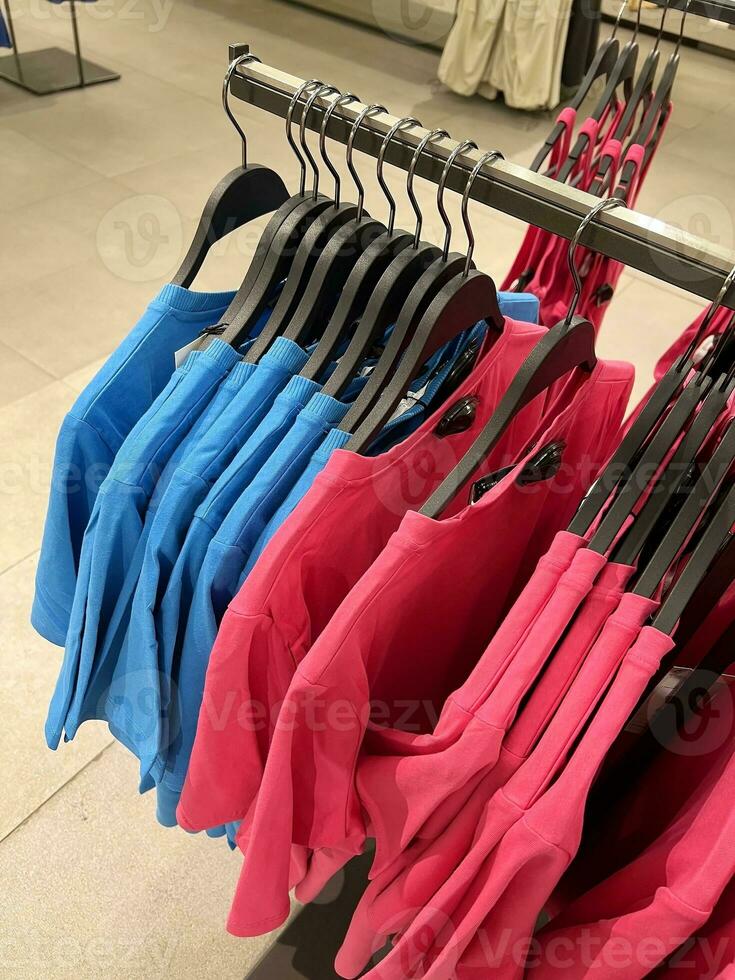 Clothes hanger boutique. Bright clothes. Style and wardrobe. photo