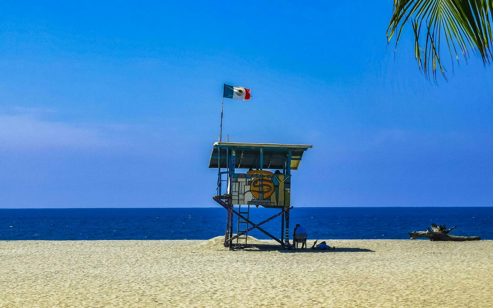 Puerto Escondido Oaxaca Mexico 2022 Beach watchtower with Mexican flag in Puerto Escondido Mexico. photo
