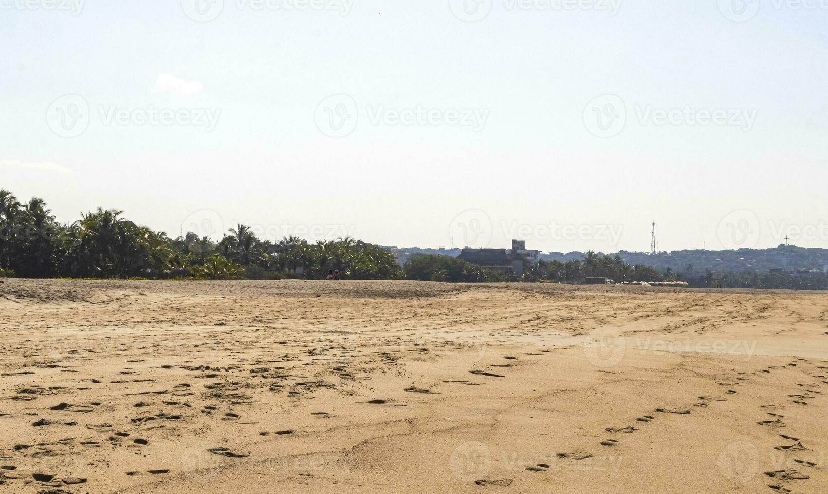 Sun beach sand people surfer waves palms Puerto Escondido Mexico. photo