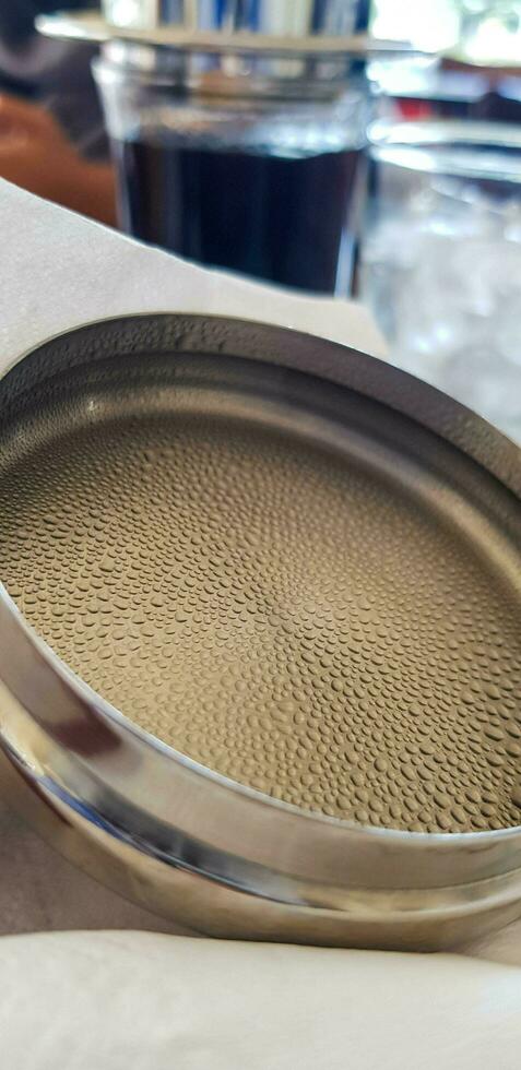 Water condensation on the lid of a stainless steel glass photo