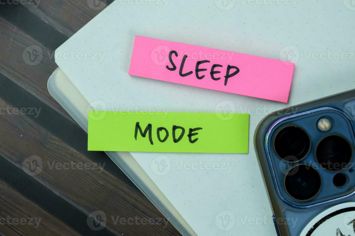 Concept of Sleep Mode write on sticky notes isolated on Wooden Table. photo