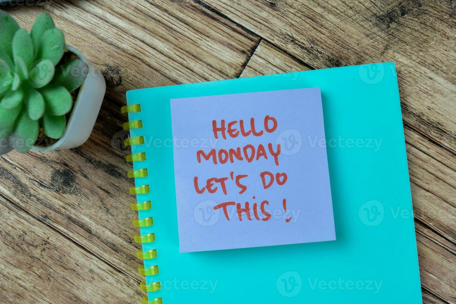 Concept of Hello Monday Let's Do This write on sticky notes isolated on Wooden Table. photo