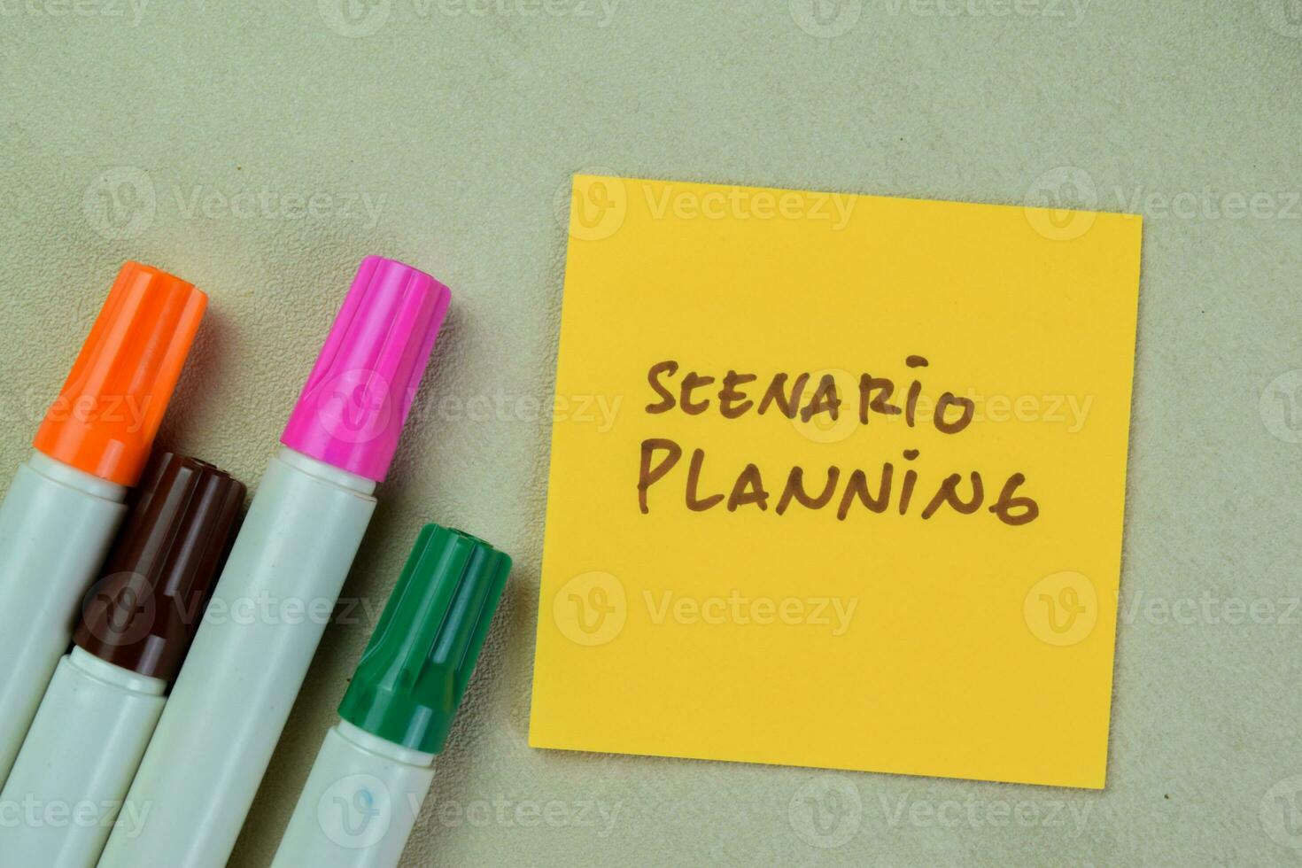 Concept of Scenario Planning write on sticky notes isolated on Wooden Table. photo