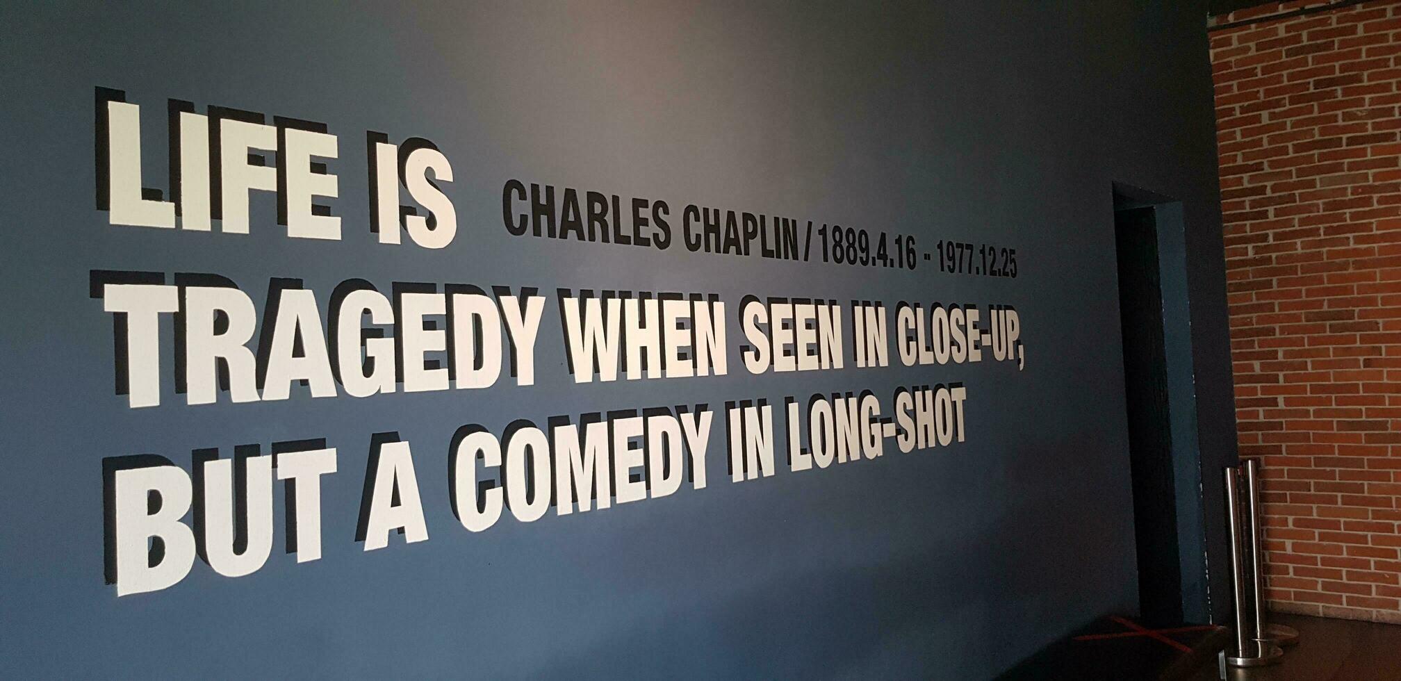 Jakarta, Indonesia in March 2019. One corner of a movie theater that has a quote from Charles Chaplin, Life is a tragedy when seen in close up, but a comedy in long shot. photo