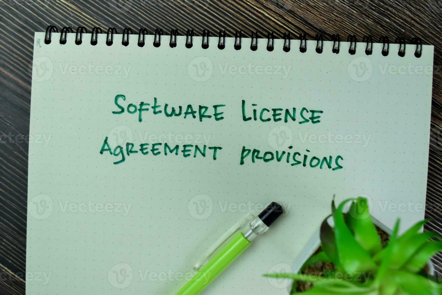 Concept of Software License Agreement Provisions write on a book isolated on Wooden Table. photo