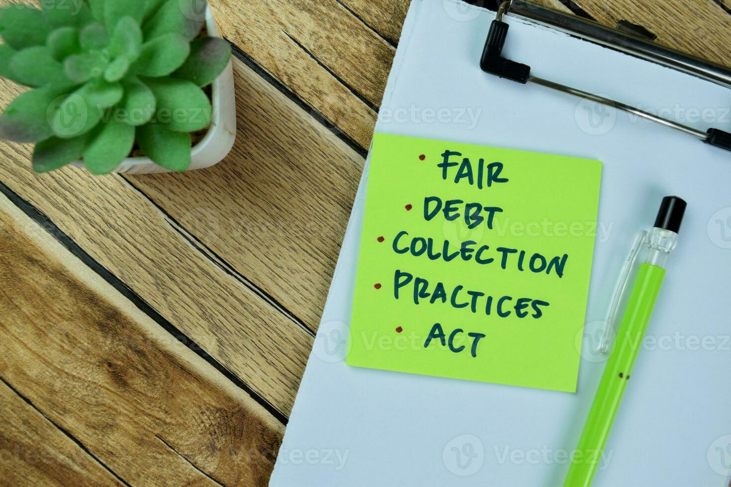 Concept of Fair, Debt, Collection, Practices, Act write on sticky notes isolated on Wooden Table. photo