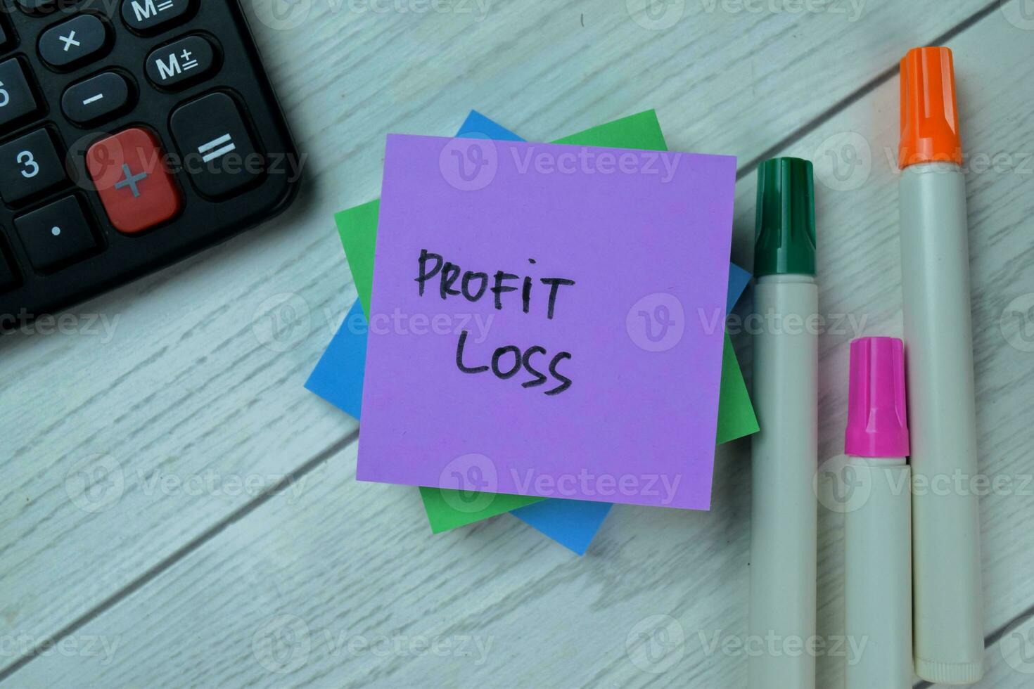 Concept of Profit Loss write on sticky notes isolated on Wooden Table. photo