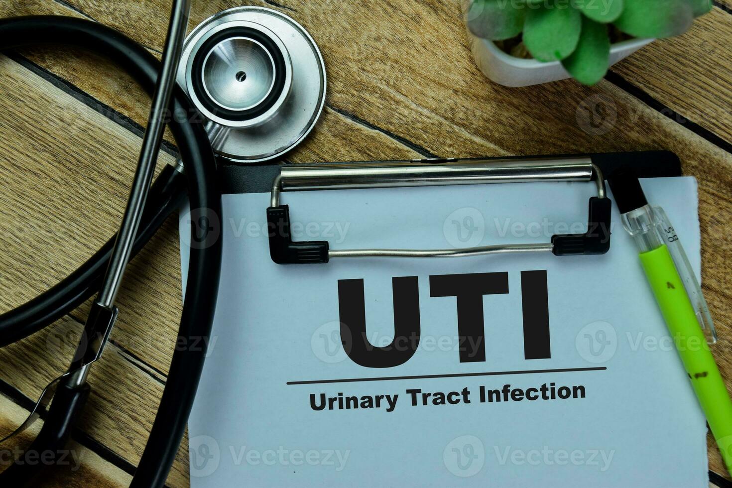 Concept of UTI - Urinary Tract Infection write on paperwork isolated on Wooden Table. photo