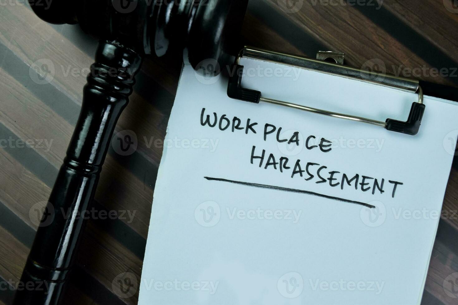 Concept of Workplace Harassement write on paperwork isolated on Wooden Table. photo