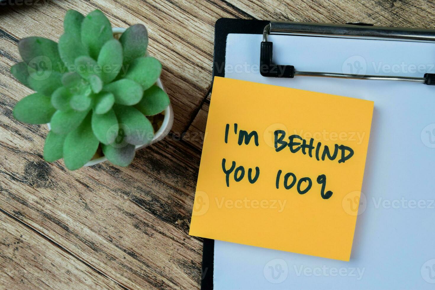 Concept of I'm Behind You 100 percent write on sticky notes isolated on Wooden Table. photo