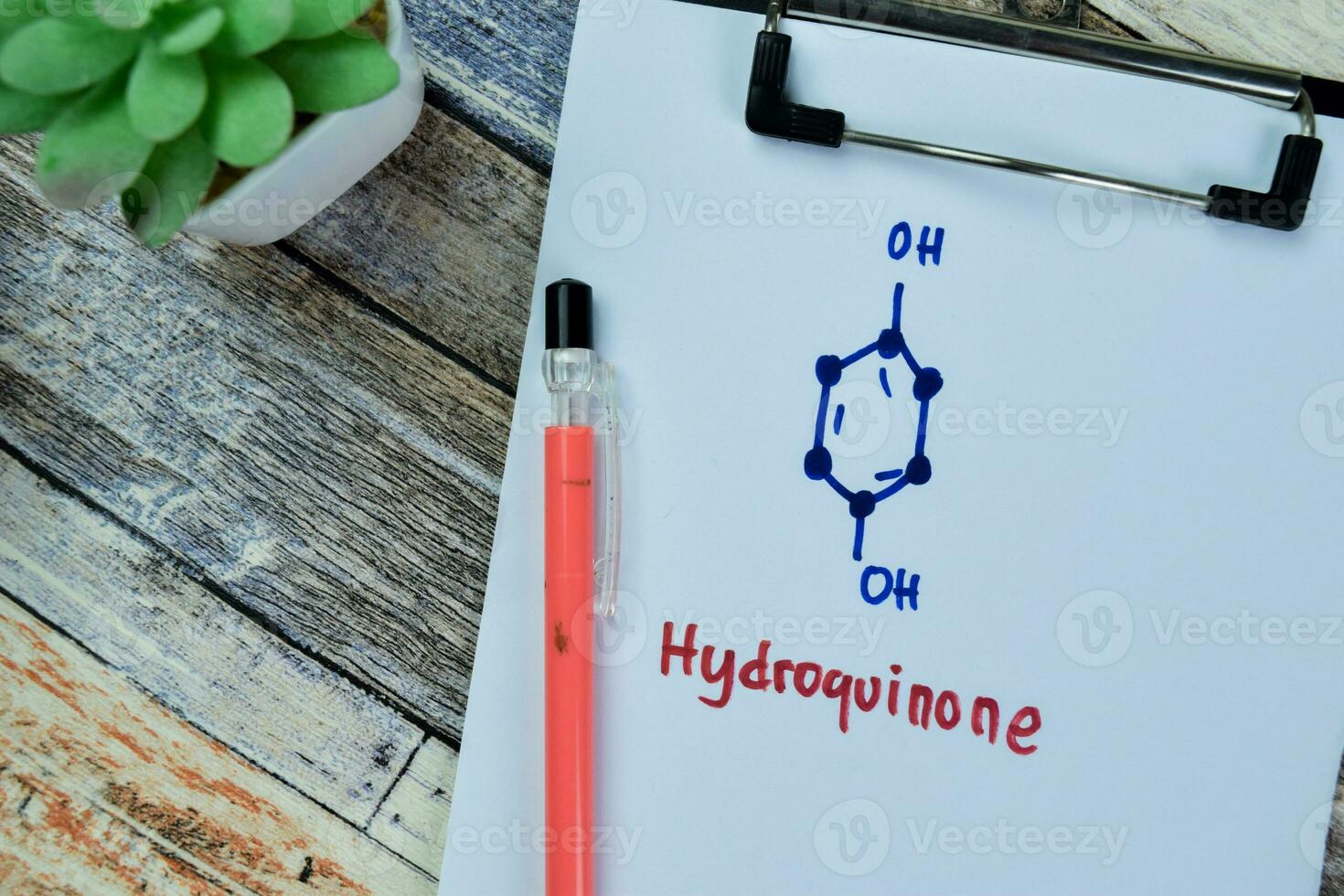 Concept of Hydroquinone write on paperwork, structural chemical formula isolated on Wooden Table. photo
