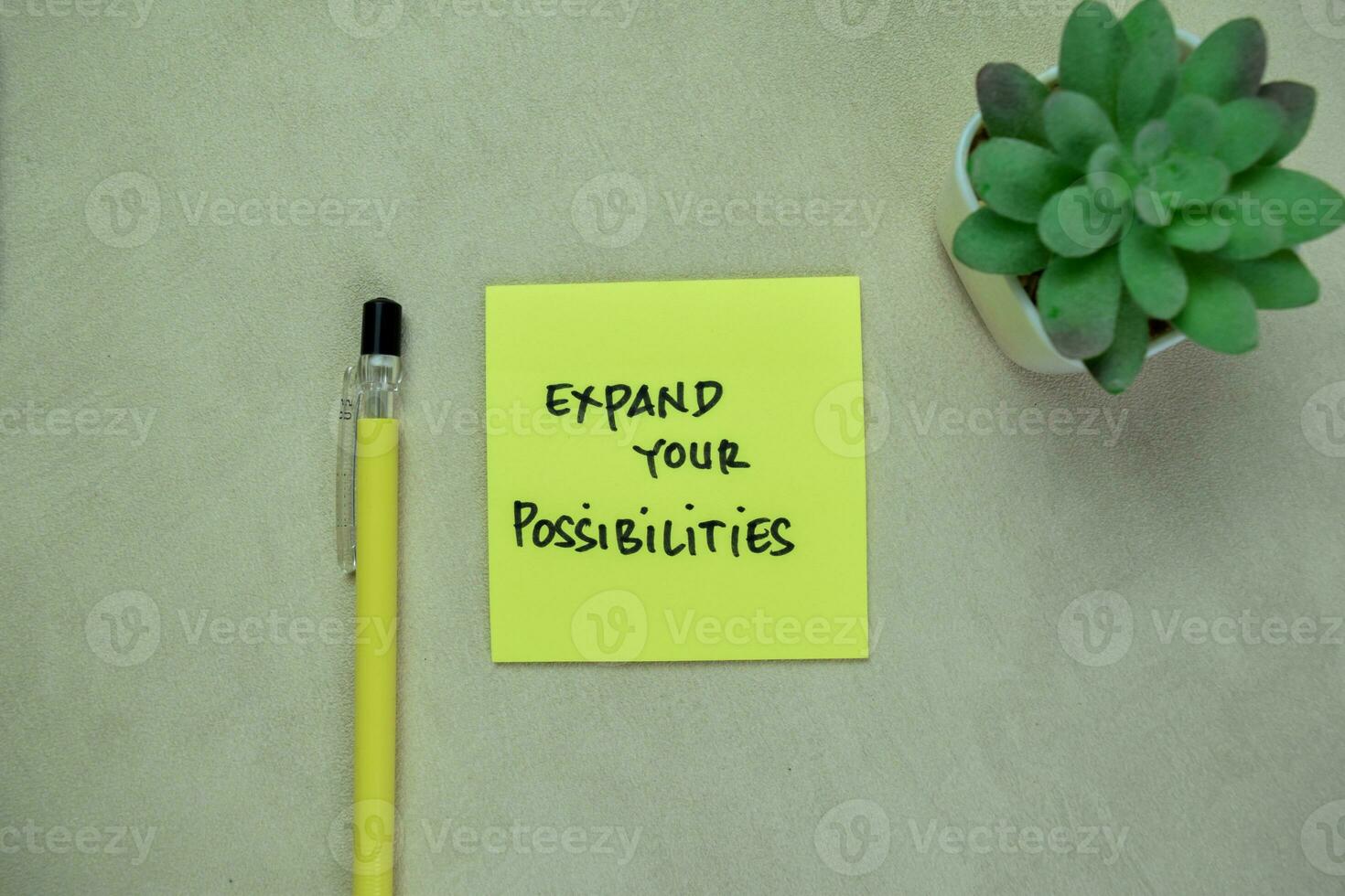 Concept of Expand Your Possibilities write on sticky notes isolated on Wooden Table. photo