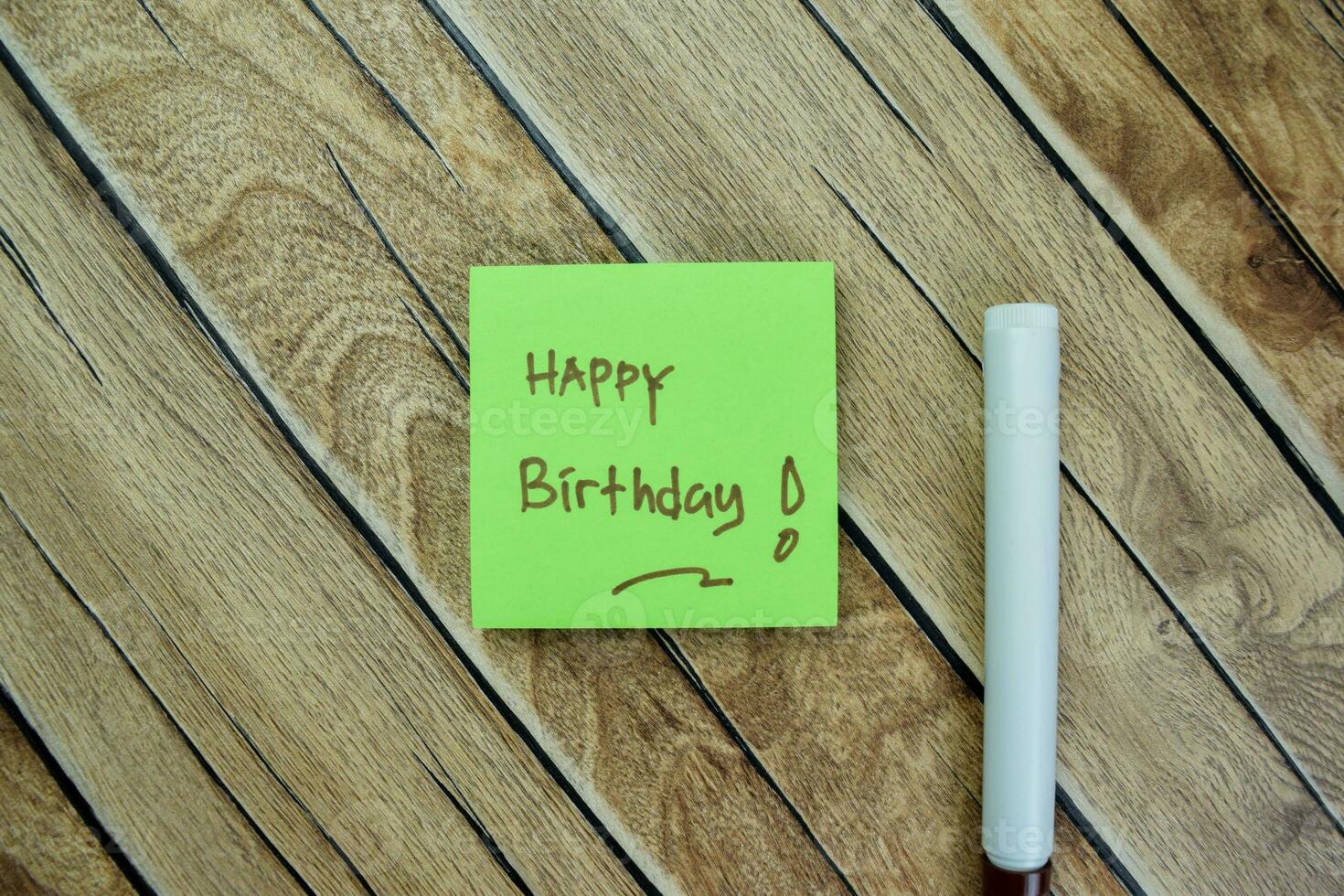 Concept of Happy Birthday write on sticky notes isolated on Wooden Table. photo