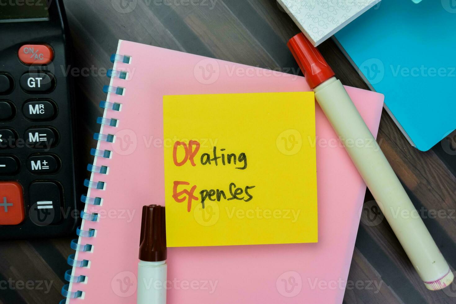 Concept of Operating Expenses write on sticky notes isolated on Wooden Table. photo