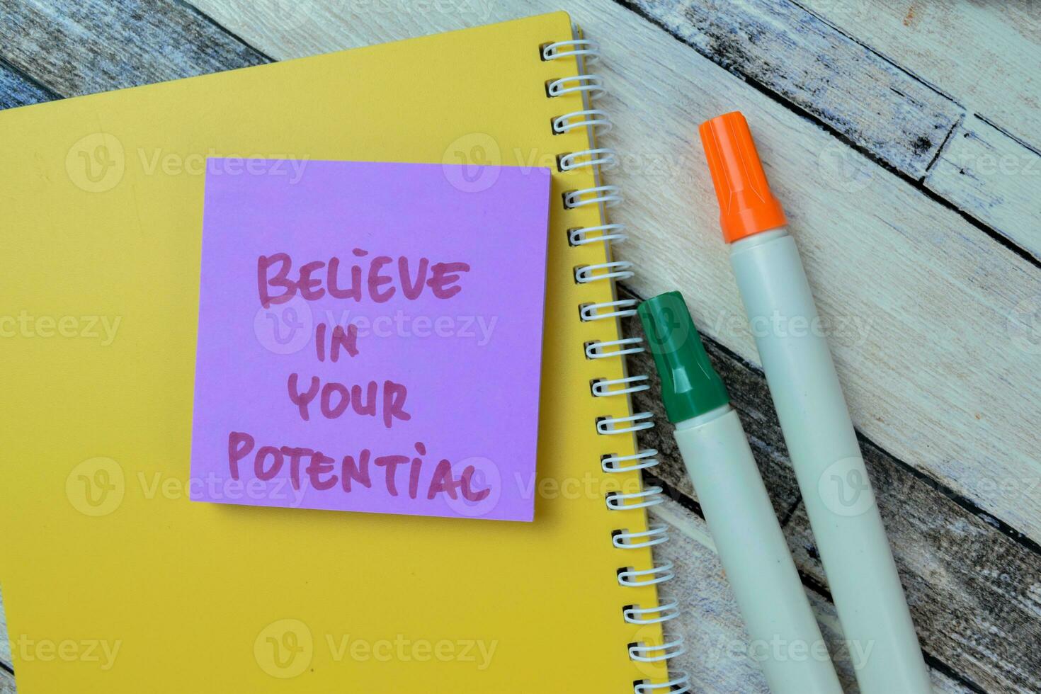 Concept of Believe in Your Potential write on sticky notes isolated on Wooden Table. photo