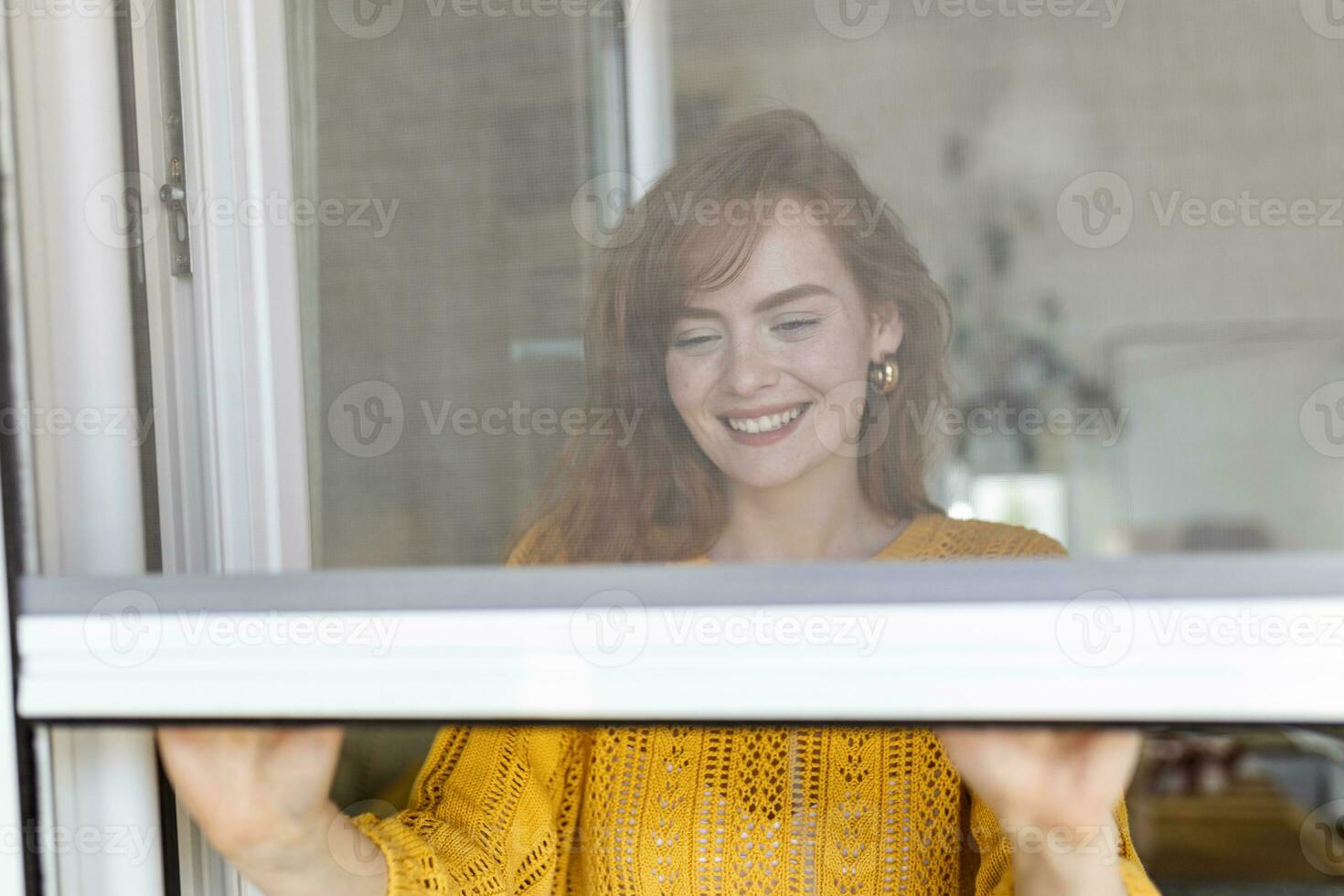 Woman hand hold retractable pleated insect screen holder to open or close the window ,mosquito nets photo