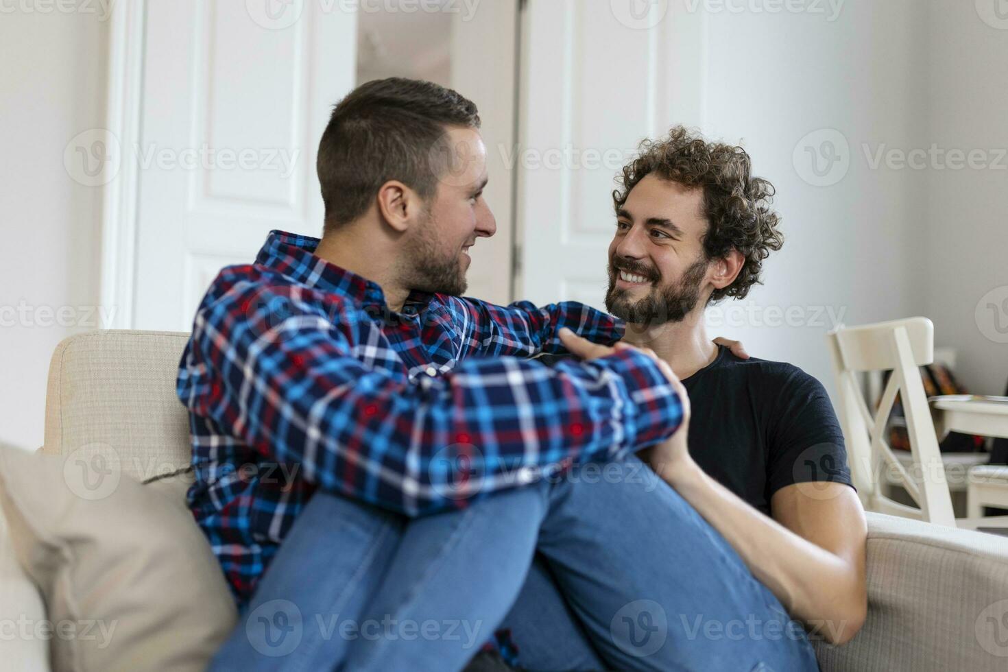 Loving Same Sex Male Gay Couple Lying On Sofa At Home And Relaxing, cuddling Together photo