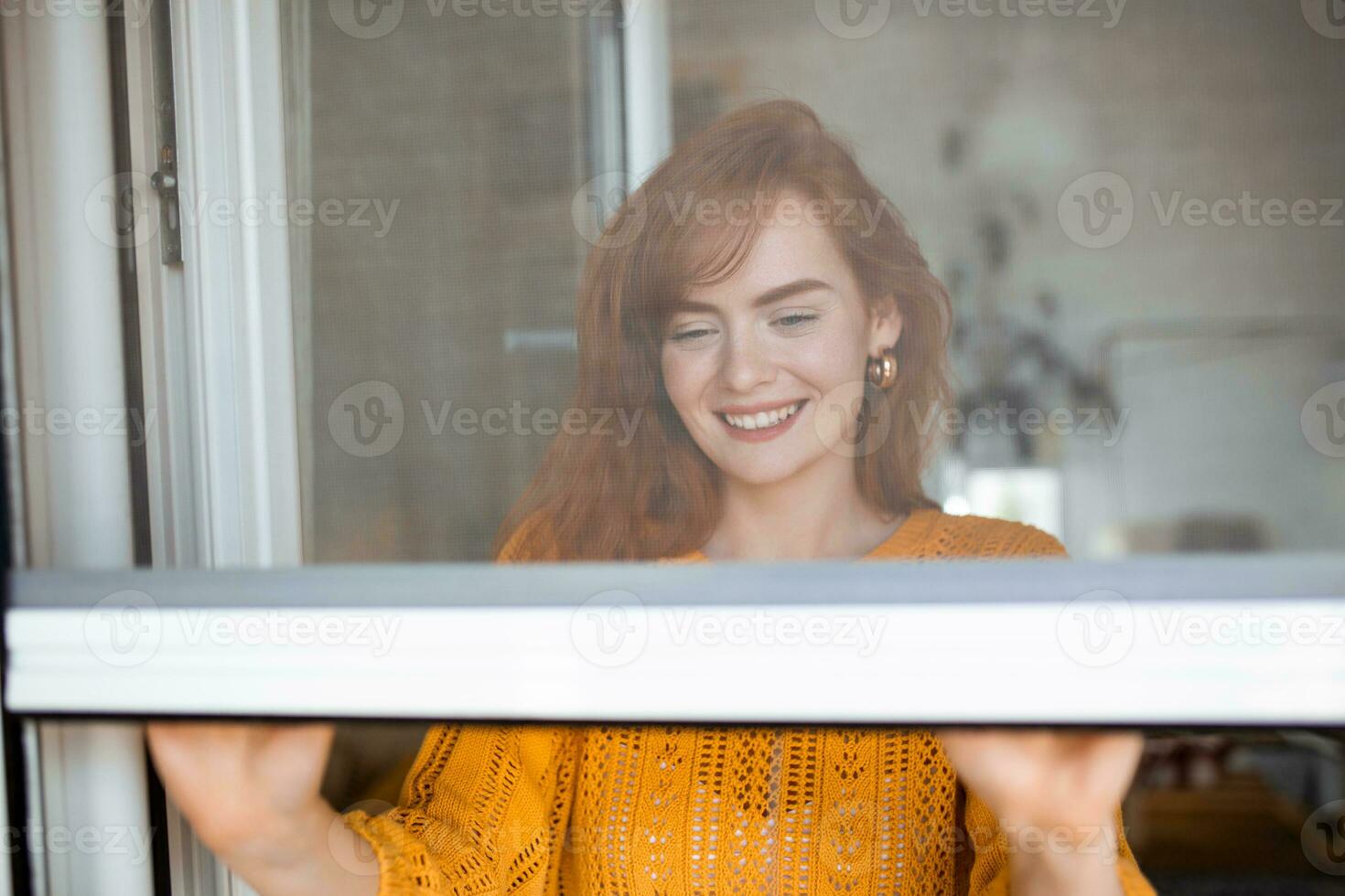 Woman hand hold retractable pleated insect screen holder to open or close the window ,mosquito nets photo
