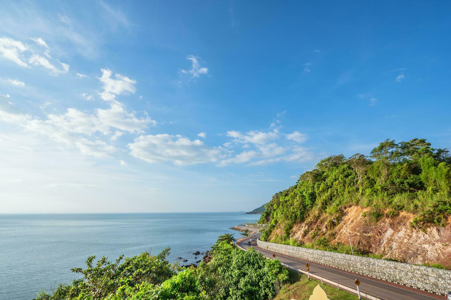 Beautiful seascape view with the mountain at noen nangphaya viewpoint chanthaburi thailand.Popular waterfront photo spot with a backdrop of the curving coastal road