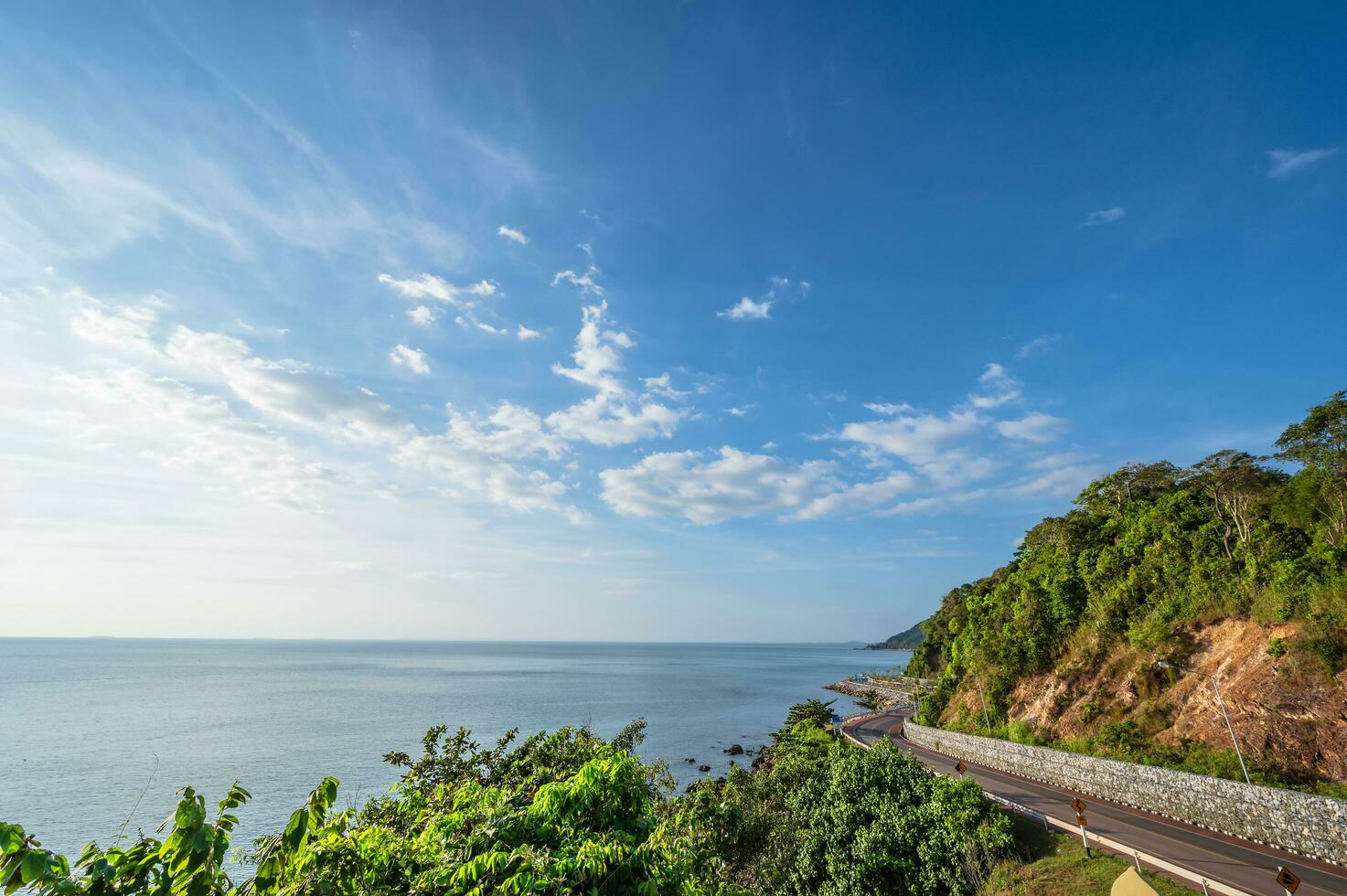 Beautiful seascape view with the mountain at noen nangphaya viewpoint chanthaburi thailand.Popular waterfront photo spot with a backdrop of the curving coastal road