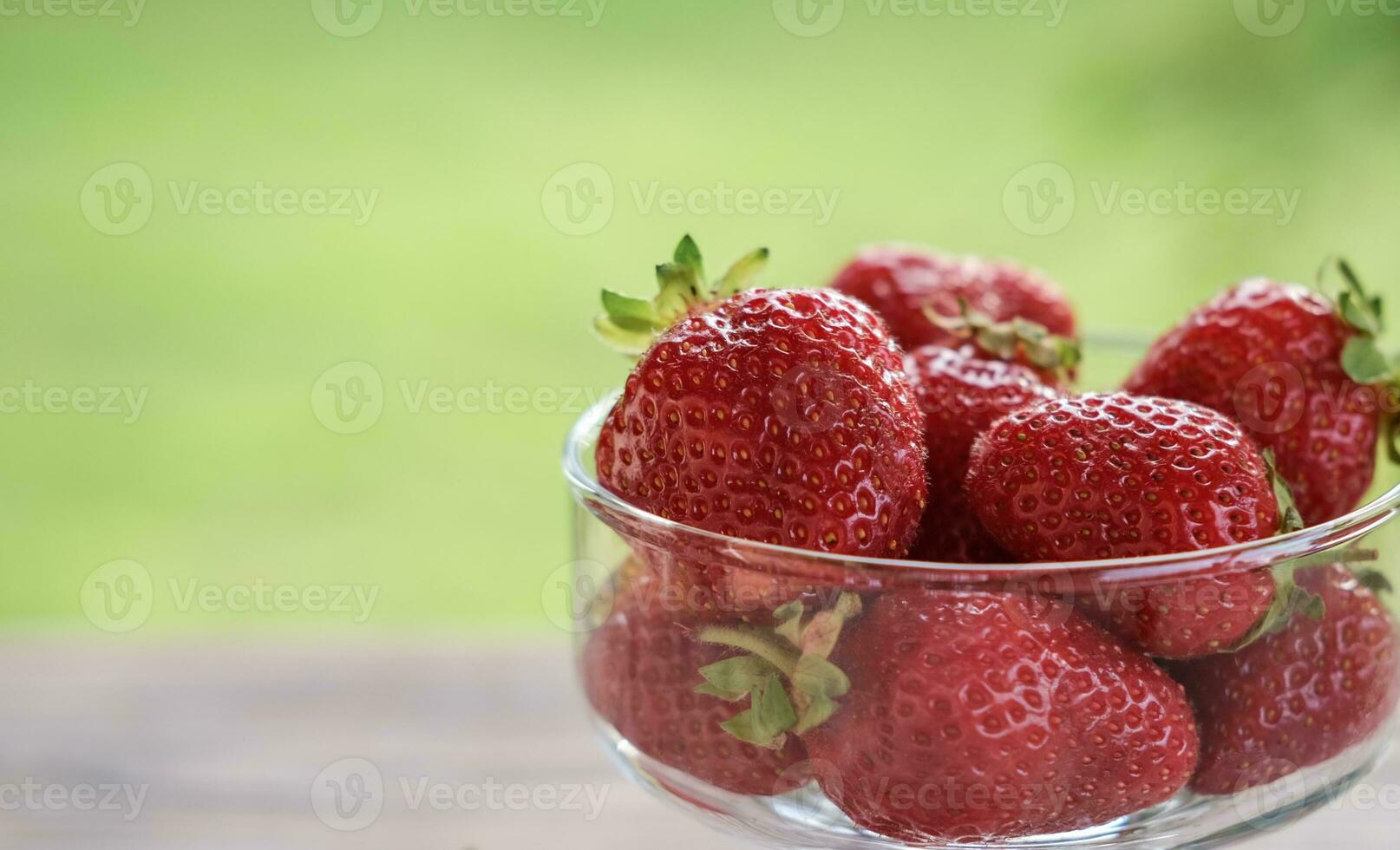 Close up of ripe strawberries in a glass bowl photo