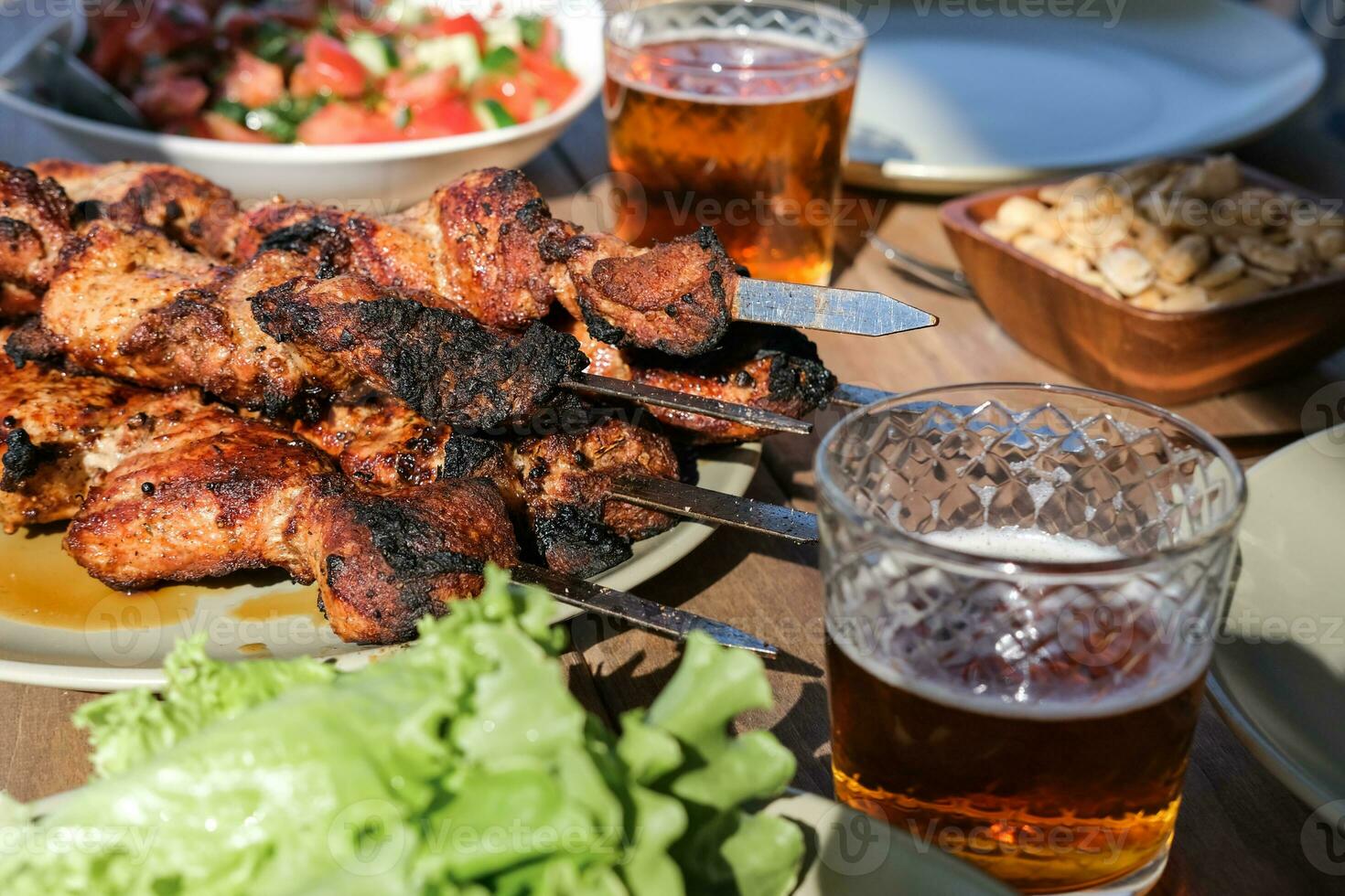 Summer picnic with barbecue, vegetables and beer photo