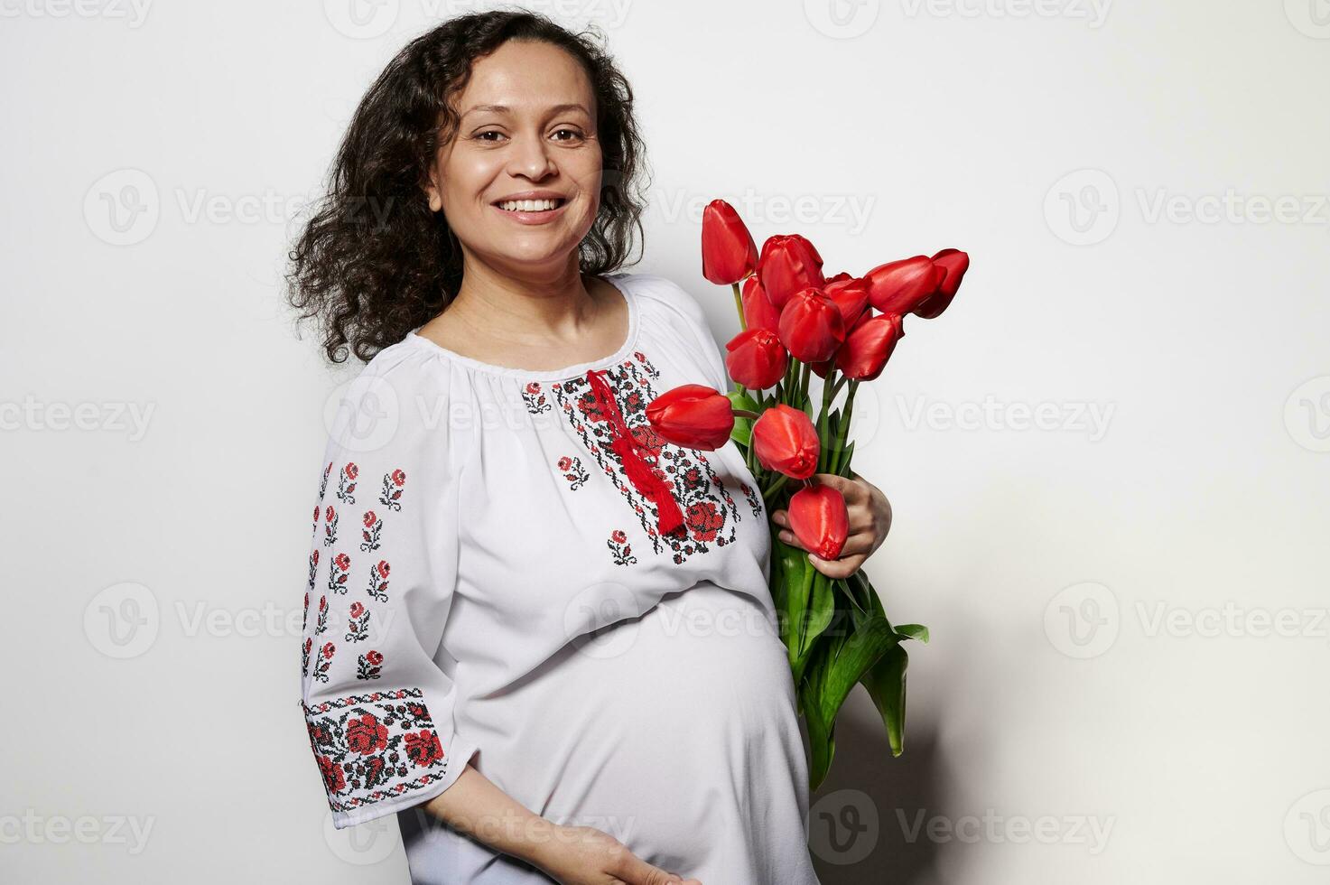 Beautiful ethnic pregnant woman wearing Ukrainian traditional embroidered clothing. People Culture Folklore Traditions photo