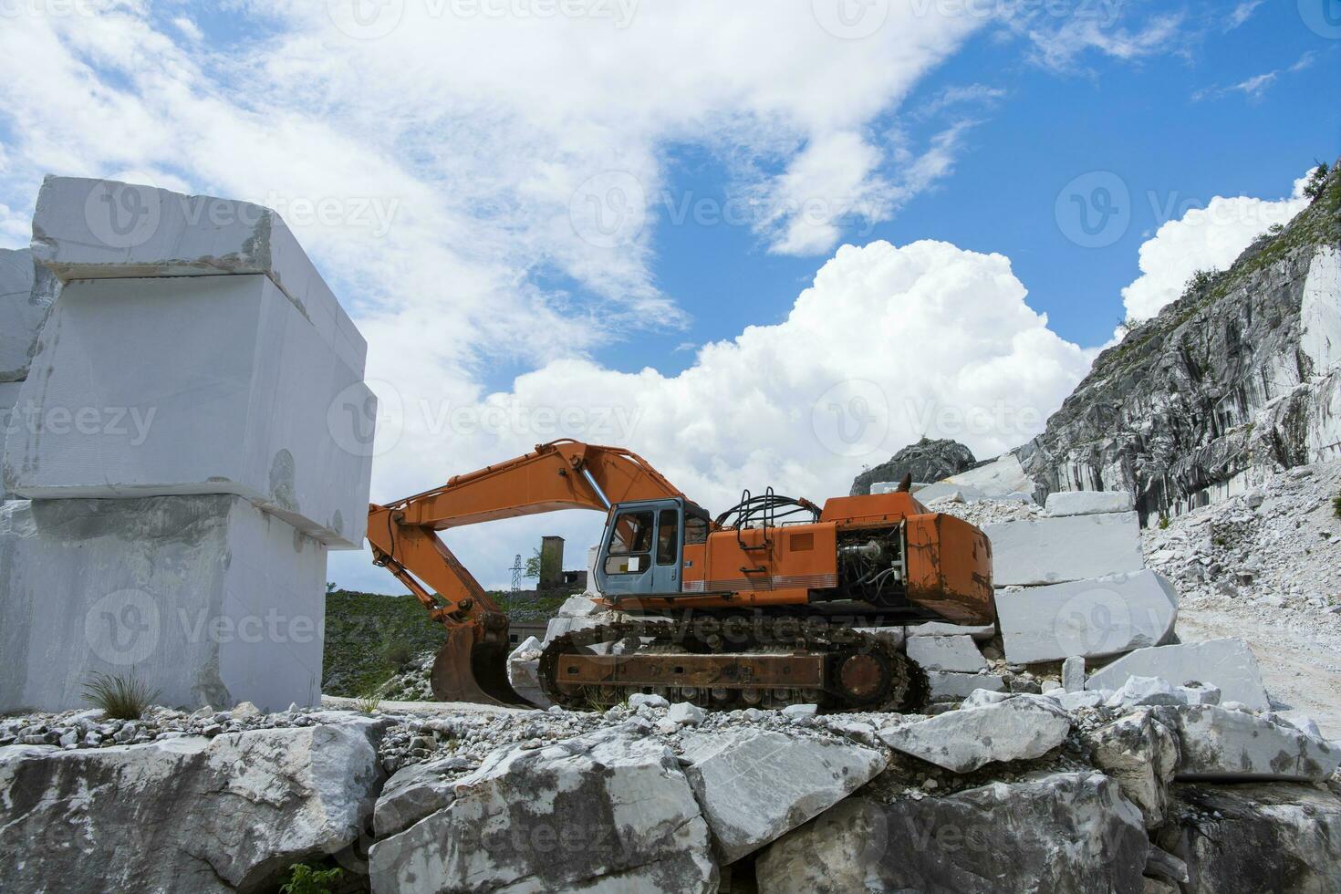 An excavator in a marble quarry Massa Carrara Tuscany Italy photo