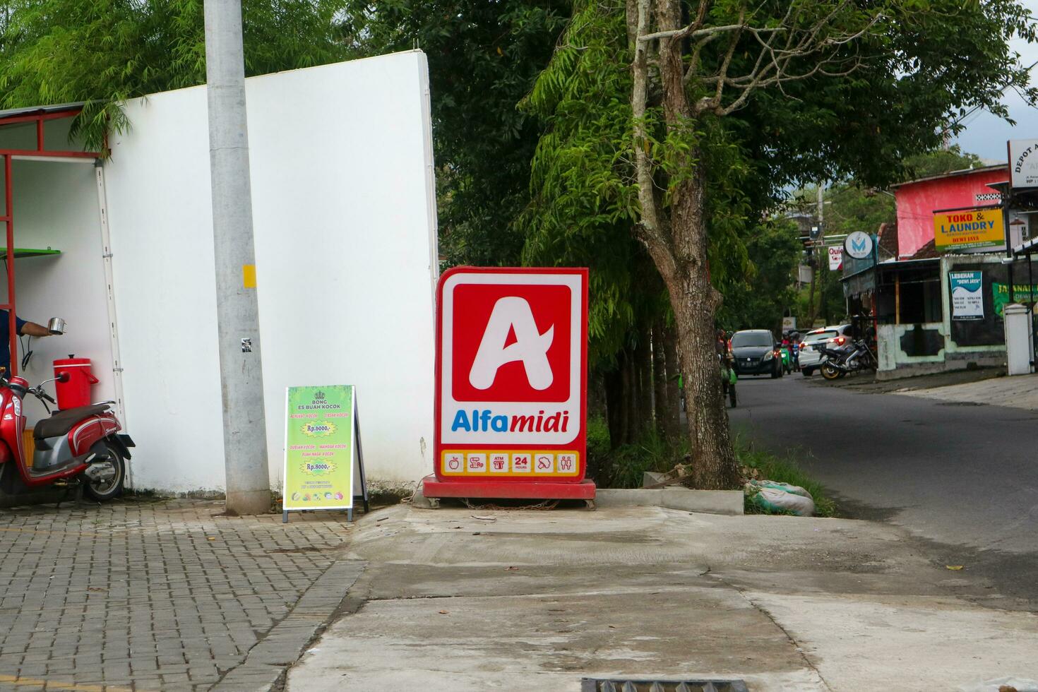 Yogyakarta, Indonesia - March 19, 2023 - Signage of Alfamidi Convenience Store. Alfamidi is group of Alfamart. Logo, symbol, banner and big board. photo
