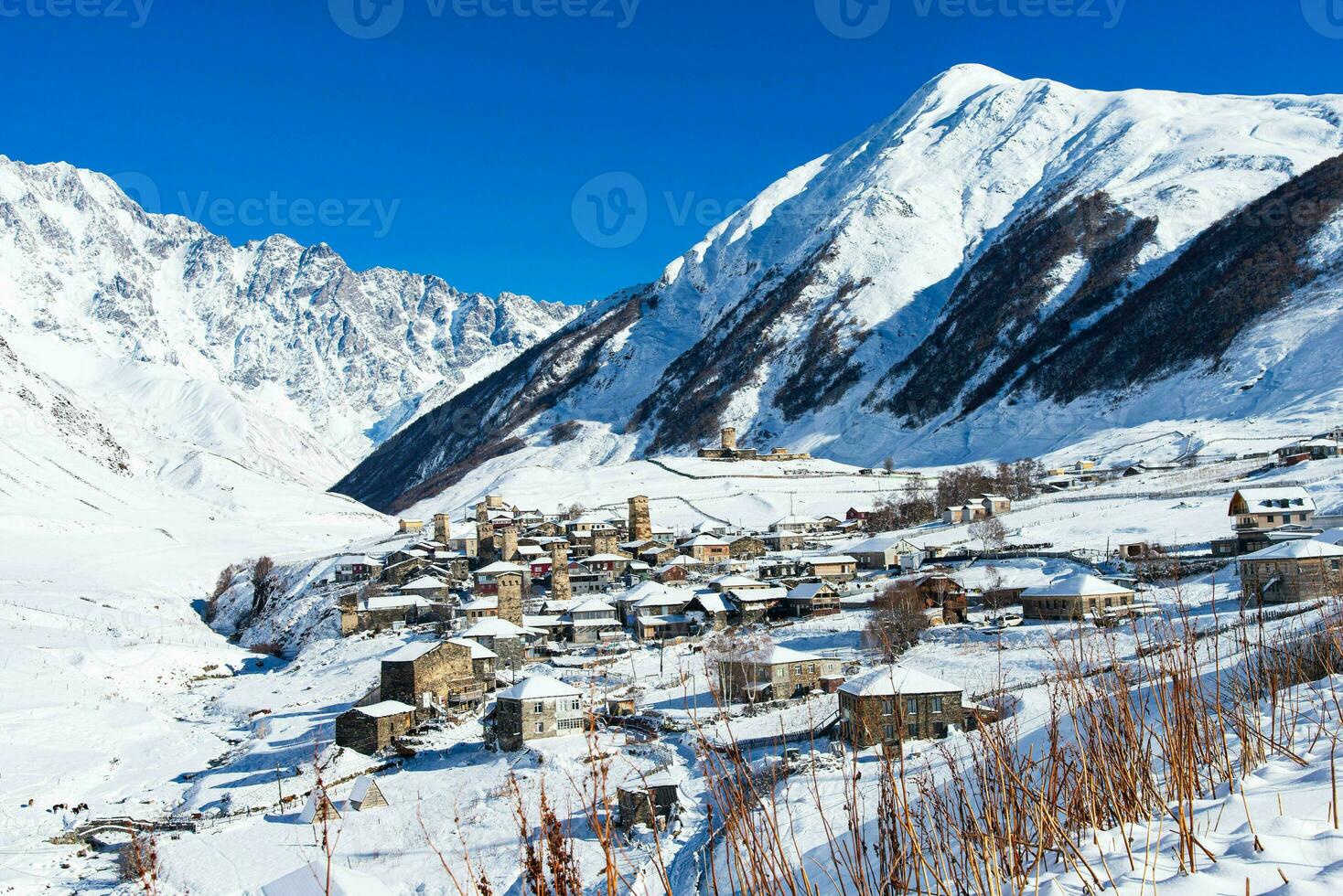 Small village in winter with Caucasus mountain. Ushguli famous landmark in Svaneti Georgia is one of the highest settlements in Europe. photo