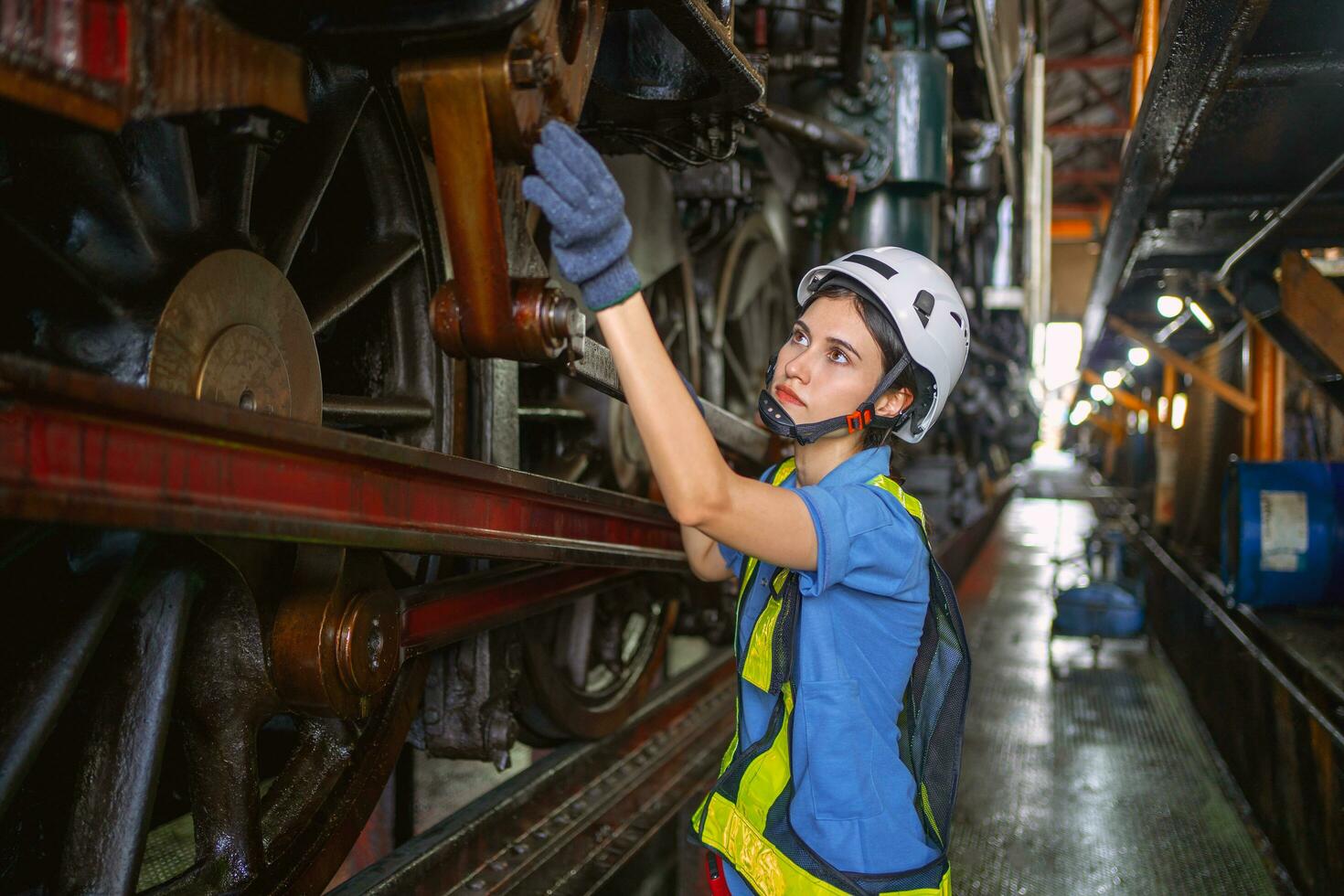 Female engineer checking equipment in factory for repair photo