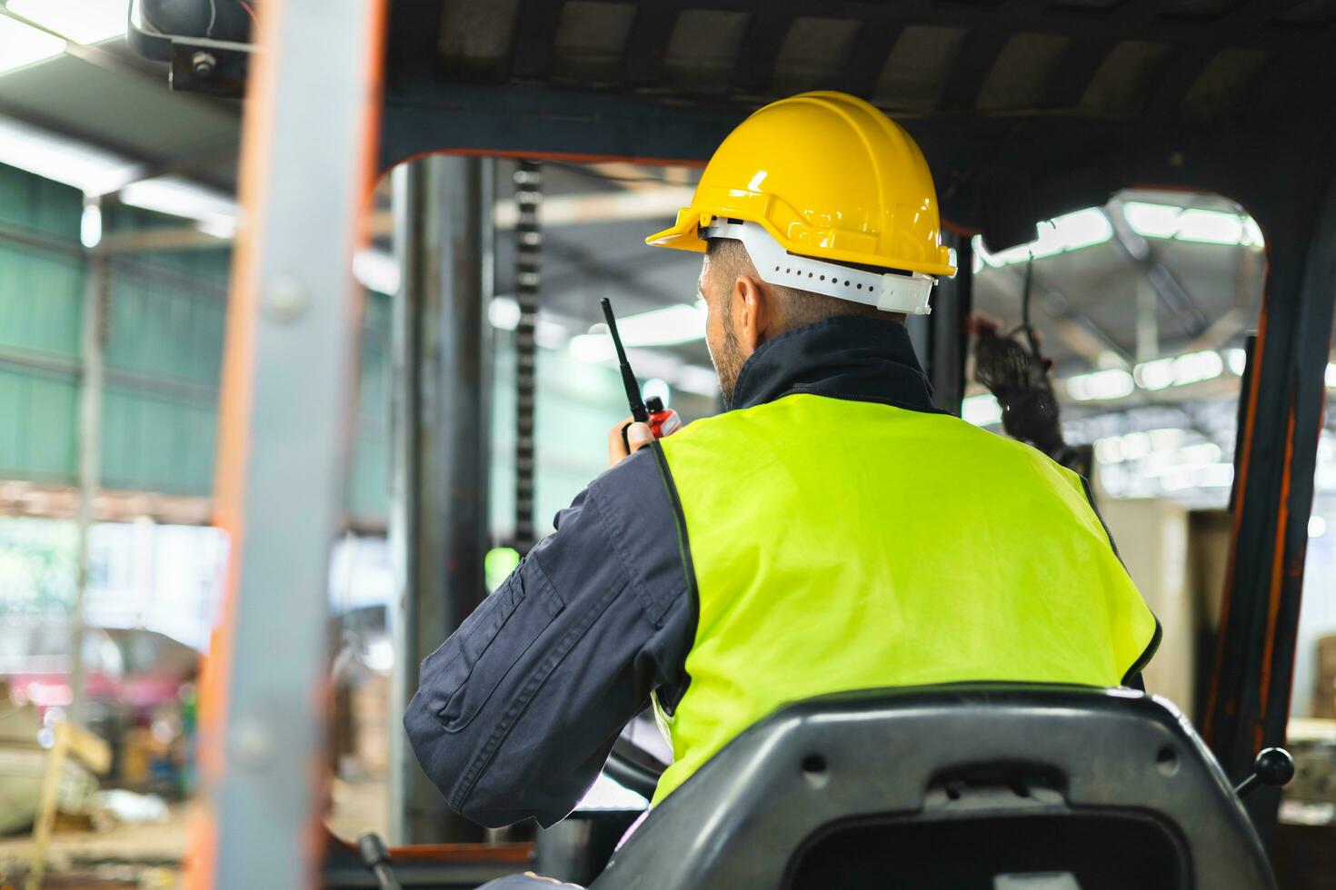 Forklift driver talking on radio for professional cargo shipping communication photo