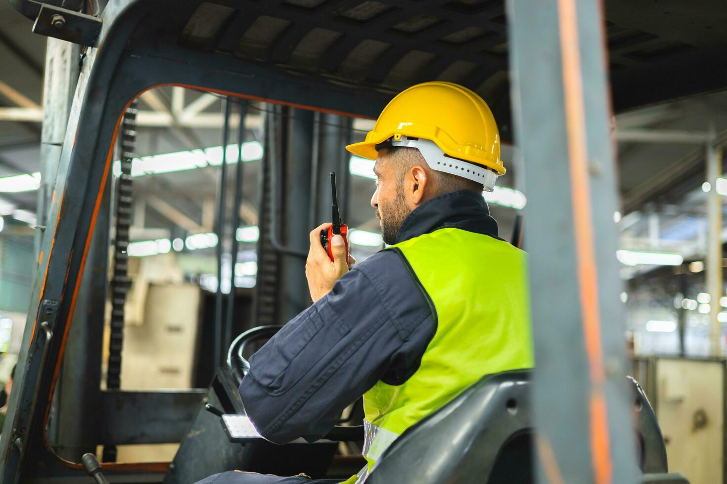 Forklift driver talking on radio for professional cargo shipping communication photo