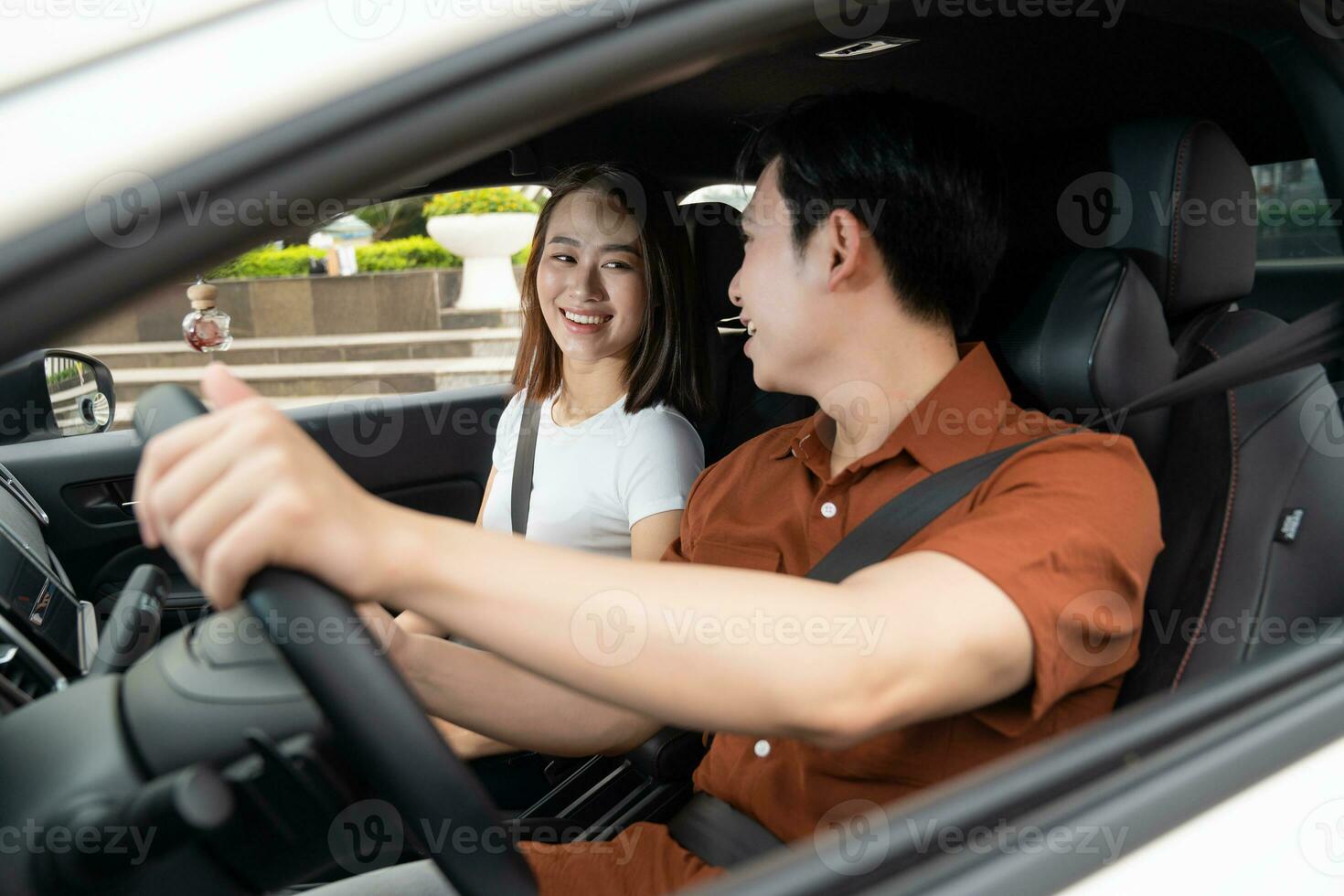 Image of young Asian couple with car photo