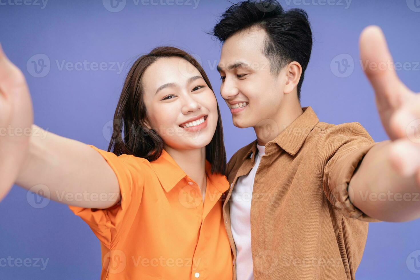 Photo of young Asian couple on background