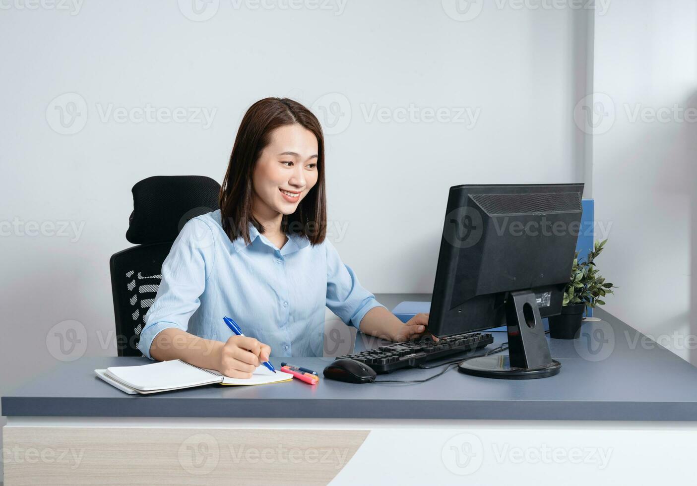 Photo of young Asian businesswoman working at office