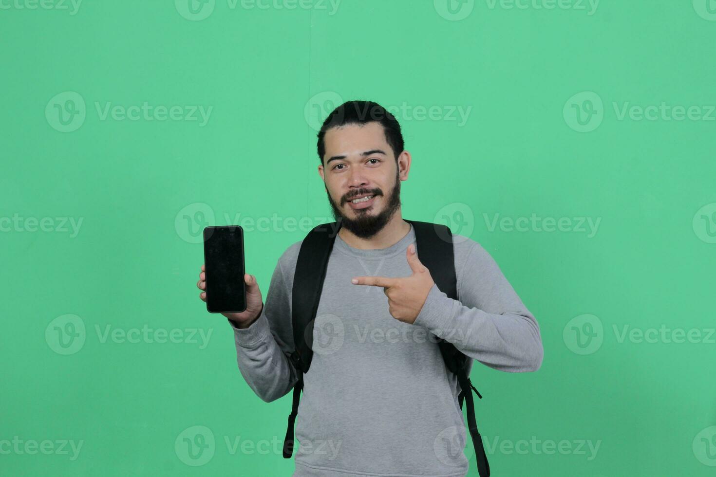 bearded asian student expression using smartphone photo