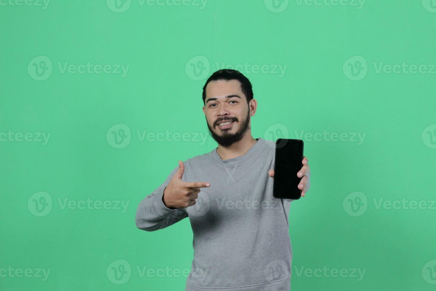 asian man expression while using smartphone photo