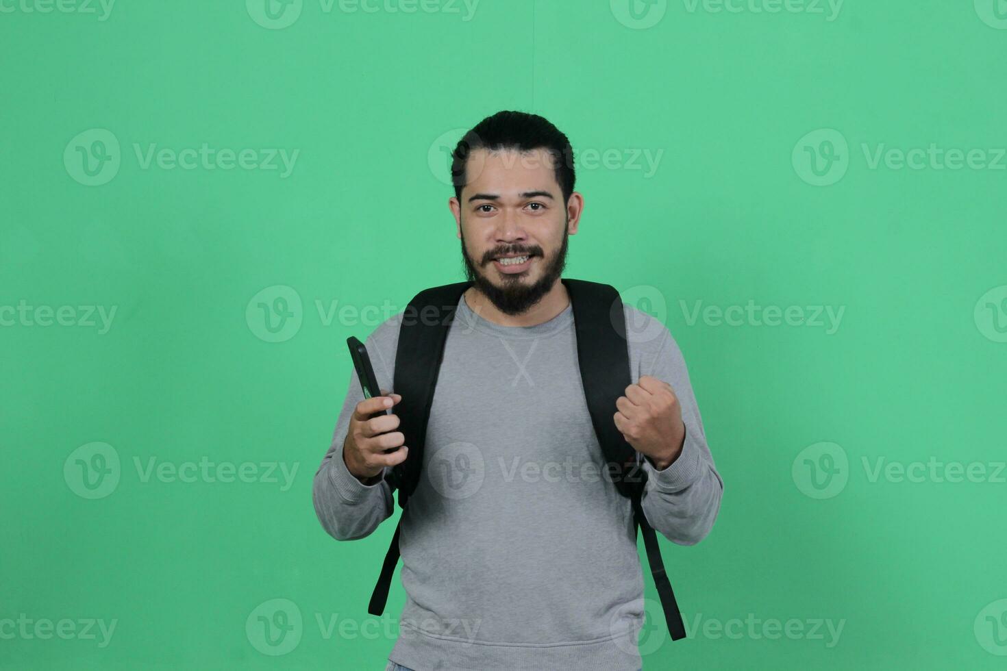 bearded asian student expression using smartphone photo