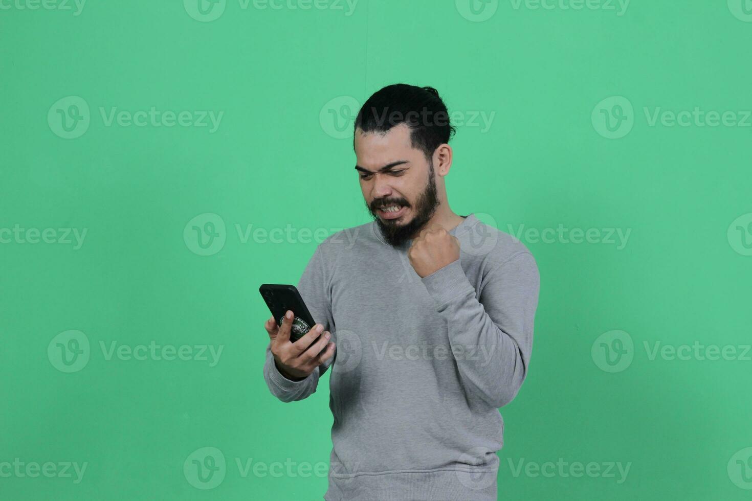 asian man expression while using smartphone photo