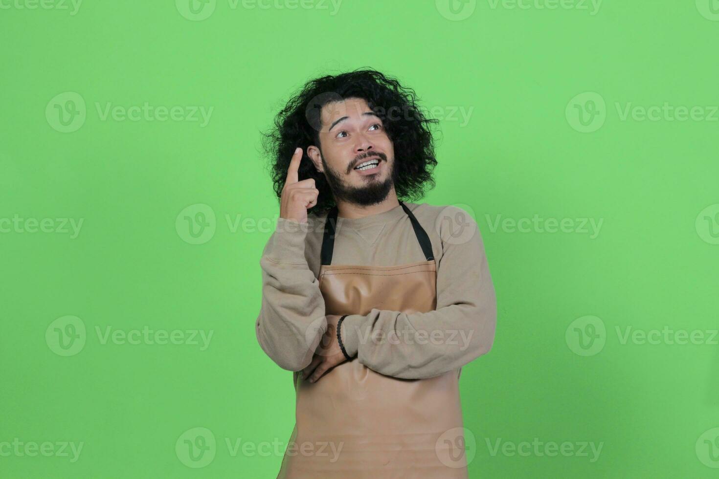 pose of a male bartender wearing a brown apron photo