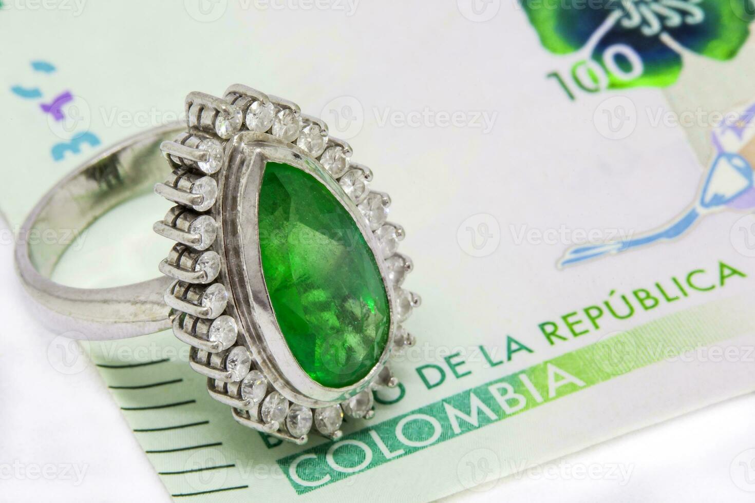 Colombian Emerald Ring and 2016 issued bills. Luxury concept. Wealth concept photo