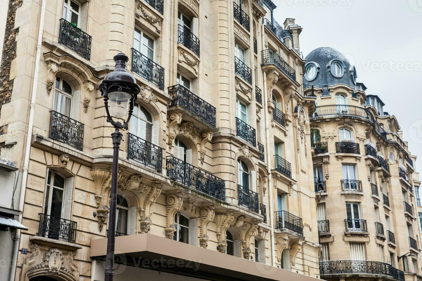 Facade of the antique buildings at Danton street in Paris France photo