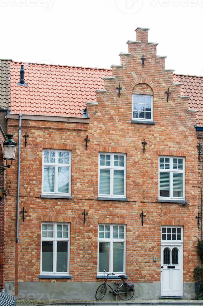 Bicycle and traditional houses at the historic town of Bruges photo