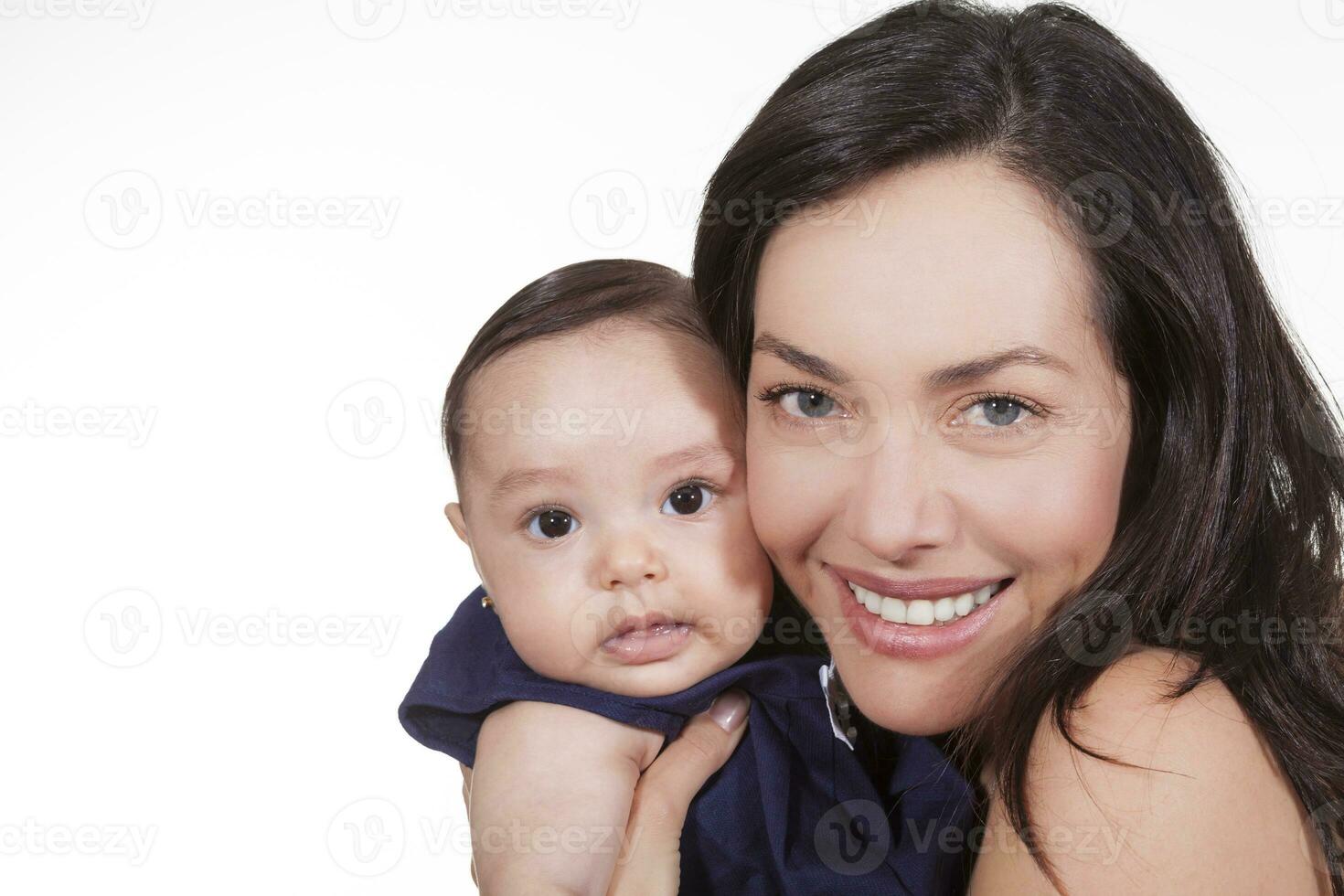 Mother and her baby girl looking at the camera photo