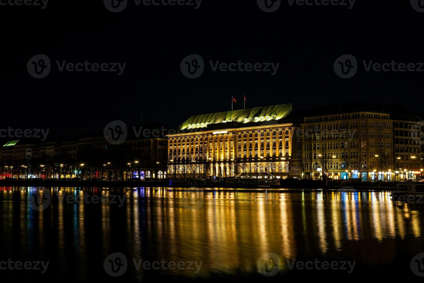 View of the Inner Alster Lake shore at night time in Hamburg photo