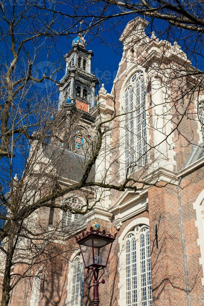 Facade of the historic Dutch protestant Western Church located at the Old Central district in Amsterdam photo